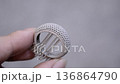 Object printed on 3D printer from metal powder by laser sintering. Woman holding metal ring in hand created on metal 3D printer. Selective laser melting technology. New modern 3D printing technologies 136864790