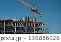 Construction of a building. Construction site with crane. Business, development, industry. 136886026