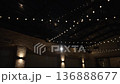 Atmospheric wedding venue setup with elegant table settings, glowing candles, and decorative lanterns creating a warm and romantic ambiance. Beautiful reception d cor prepared for guests, cozy evening 136888677