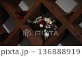 Atmospheric wedding venue setup with elegant table settings, glowing candles, and decorative lanterns creating a warm and romantic ambiance. Beautiful reception d cor prepared for guests, cozy evening 136888919