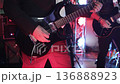 Close-up of a guitarist playing an electric guitar, detailed shot of hands moving over the strings and fretboard. Dynamic performance moment with expressive finger movement, music energy, and live 136888923