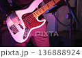 Close-up of a guitarist playing an electric guitar, detailed shot of hands moving over the strings and fretboard. Dynamic performance moment with expressive finger movement, music energy, and live 136888924