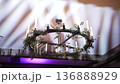Atmospheric wedding venue setup with elegant table settings, glowing candles, and decorative lanterns creating a warm and romantic ambiance. Beautiful reception d cor prepared for guests, cozy evening 136888929