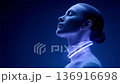 Futuristic woman wearing a glowing necklace 136916698