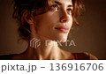 Close-up of a woman's profile showing elegance in light and shadow 136916706