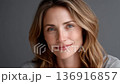 Close-up of a confident mature woman's face, showcasing her intellectual charm 136916857