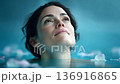 Close-up of a calm woman's face underwater 136916865