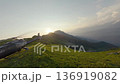 Land helicopter spinning blades on sunset mountain summit aerial view 136919082