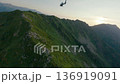 Helicopter at sunset mountain valley ridge aerial follow view 136919091