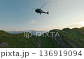 Side view helicopter at sunset mountain valley ridge aerial view 136919094