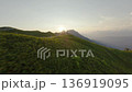 FPV drone man pilot standing on mount top near helicopter on sunset 136919095