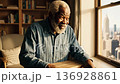 Elderly african american man admiring city view from window 136928861