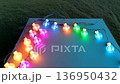 Color-changing LED bulbs pulsing rhythmically against a vibrant backdrop at a festive gathering 136950432