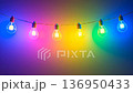 Color-changing LED bulbs pulsing rhythmically against a vibrant backdrop at a festive gathering 136950433