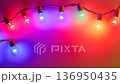 Color-changing LED bulbs pulsing rhythmically against a vibrant backdrop at a festive gathering 136950435