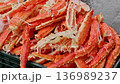 Wholesale supplier loads crab legs into boxes for shipment 136989237