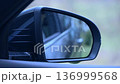 Rear view mirror adjustment. Reflections of a journey captured in the car's side mirror on a misty day 136999568