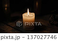 A candle is lit in the dark 137027746