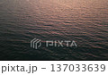 4K Aerial forward shot over calm sea water surface at sunset 137033639