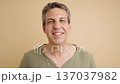Happy middle-aged man smiling joyfully at camera 137037982