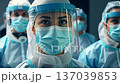 Healthcare Professionals in PPE Working Together in Hospital 137039853