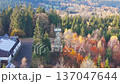 Experience the beauty of Slovanka lookout tower in the Jizera Mountains. This stunning structure offers breathtaking views of colorful fall foliage in a serene forest setting. 137047644