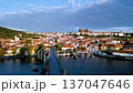 Experience the stunning views of Charles Bridge and Prague Castle at sunrise. The aerial perspective showcases the beauty of the city, the Vltava River, and historic architecture. 137047646
