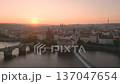 Experience the breathtaking sunrise over Old Town Prague as the city awakens. The iconic Charles Bridge and historic architecture glow in morning light, creating a magical atmosphere. 137047654