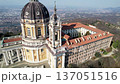 High angle drone shot reveals the majestic Basilica of Superga with its grand dome and classical portico on the hilltop in Turin, Italy, historic baroque architecture, city panorama, sunny daylight. 137051516