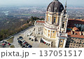 High angle drone shot shows the majestic Basilica of Superga with its grand dome and classical portico on the hilltop in Turin, Italy, historic baroque architecture, city panorama, sunny daylight. 137051517