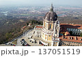 High angle drone shot shows the majestic Basilica of Superga with its grand dome and classical portico on the hilltop in Turin, Italy, historic baroque architecture, city panorama, sunny daylight. 137051519
