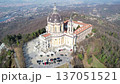 Aerial drone view of the majestic Basilica of Superga with its grand dome and monastery buildings on the hilltop in Turin, Italy, baroque architecture, urban panorama, sunny daylight scene. 137051521