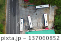uses parked beside the road, Public transport vehicles stopped on highway shoulder, Rural road with buses waiting by the side 137060852