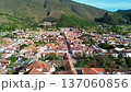 Aerial view of colonial town in the mountains, Drone flying over traditional white houses, Villa de Leyva town seen from above 137060856