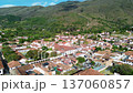Villa de Leyva aerial view from park, Colonial Colombian town with mountain background, Drone flight over historic white village 137060857
