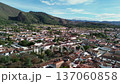 Colonial townscape with red tile roofs, Scenic aerial flight over historic architecture, Villa de Leyva Colombia from drone perspective 137060858