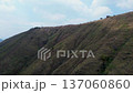 Drone flying over mountains revealing city beyond, Aerial landscape from mountains to urban skyline, Scenic drone view showing transition from nature to city Yumbo, Valle del Cauca 137060860