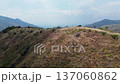 City behind the mountains seen by drone, Aerial view revealing urban area beyond hills, Drone footage showing cityscape Yumbo hidden by mountains 137060862