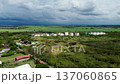 Drone footage of grain silos in farmland, Industrial silos surrounded by crops, Aerial view of agricultural storage facility 137060865