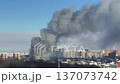 Smoke rises from buildings in the city during the day, showing the aftermath of a fire in an urban area 137073742