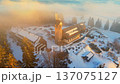 Join a trip to Kralovka lookout tower in Jizera Mountains. Explore the snowy landscape and see the tower surrounded by trees. Enjoy views of the winter scene. 137075127