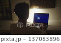 Night work scene with man coding on laptop in quiet dark room. Night work concept illustrates overtime, deep focus, programming tasks and modern digital work routine. 137083896