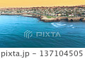 Aerial panorama of San Diego County coastline with cliffs, waves and upscale coastal neighborhood homes 137104505