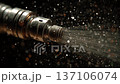 Close-up of a metal nozzle spraying water in slow motion against a black background. Industrial concept. 137106074