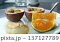 Passion fruit mandarin dessert on a white plate at an all-inclusive breakfast restaurant. 137127789