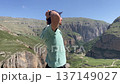 man stretching and looking at panorama mountains amateur mobile phone 137149027