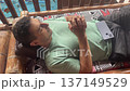 man sleeping outdoors on the terrace in funny unnatural pose travel meditation  137149529