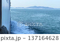 Close-up of a Ship Cutting Through Ocean Waves Creating White Foam 137164628