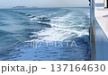 Dynamic White Wake and Foam Behind a Sailing Ship on the Blue Sea 137164630