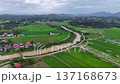 Aerial drone footage showing Labuh Banting river winding through rice paddies, village, roads and distant hills. 137168673